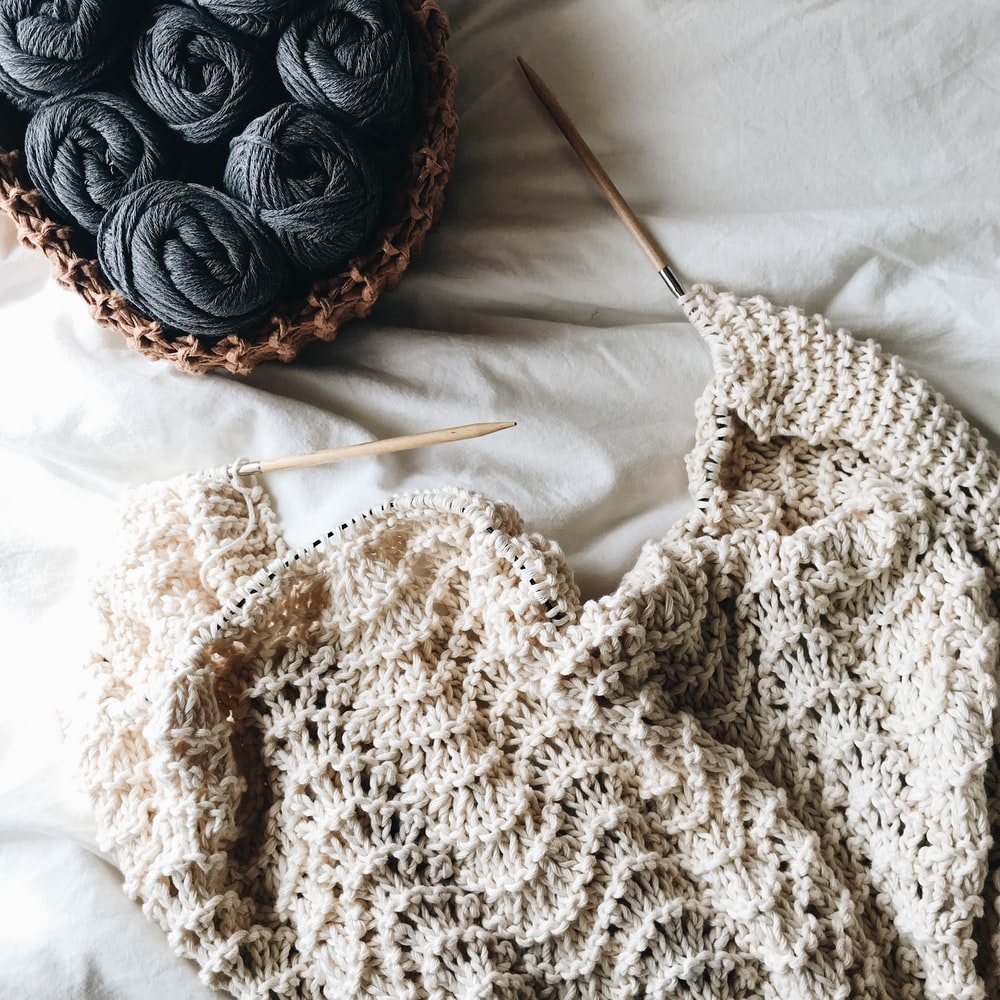 Three Round Red And White Knit Decors On White Knit Textile