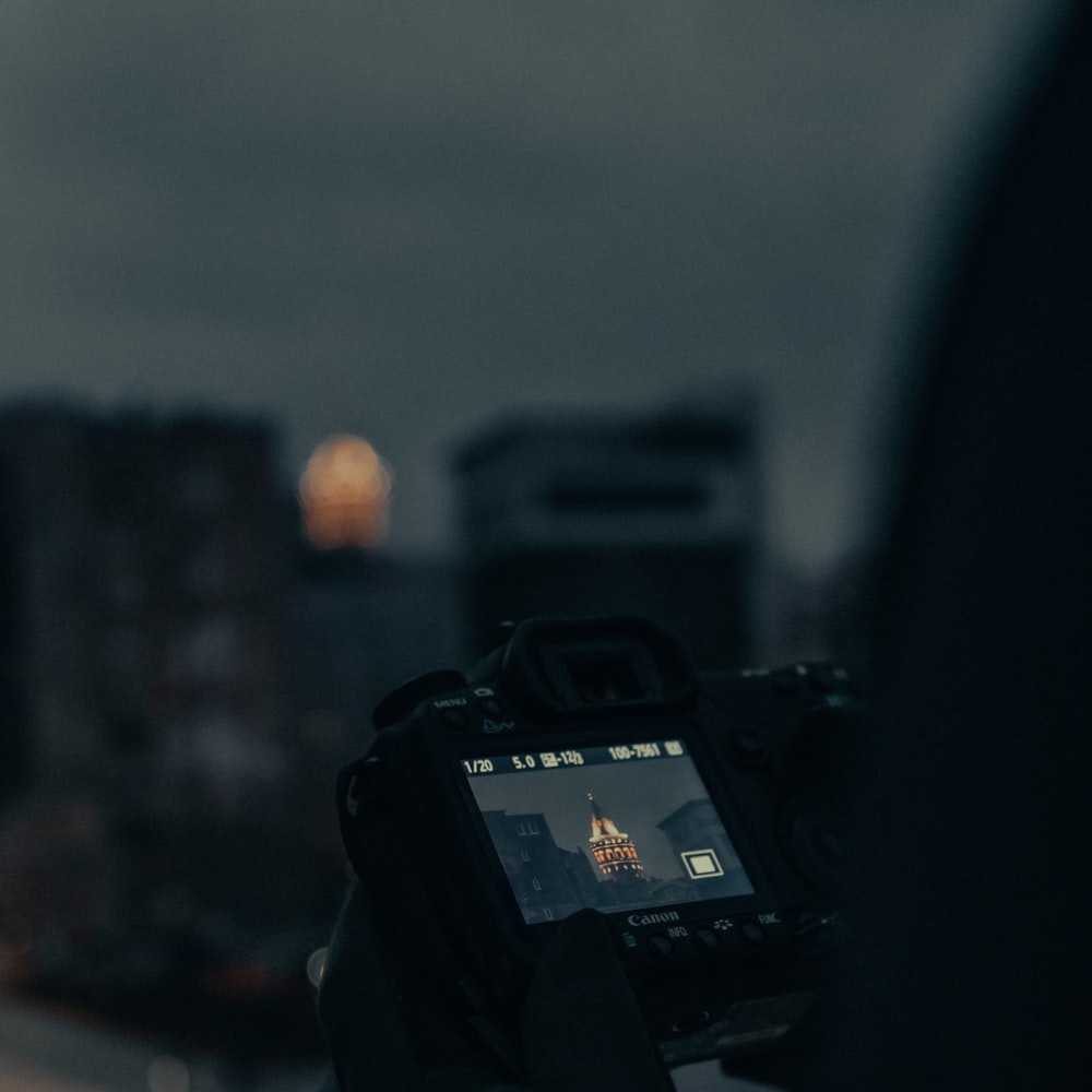 Person Holding Black Dslr Camera