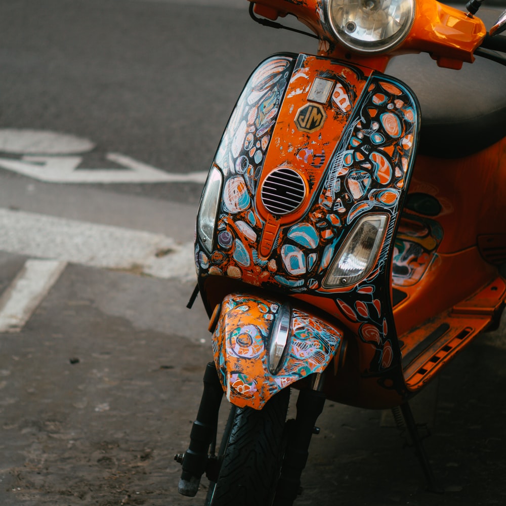 Orange And Black Motor Scooter On Road During Daytime raster image