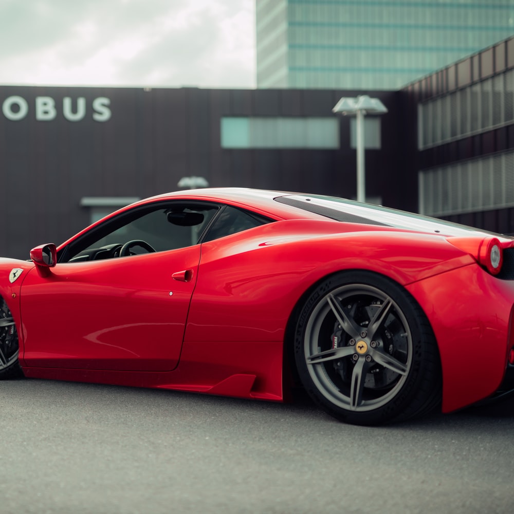 Red Ferrari 458 Italia Parked On Gray Pavement raster image