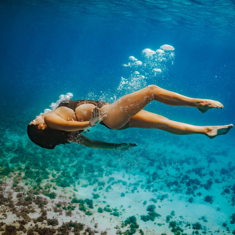 Woman In Blue Bikini Swimming In Water raster image