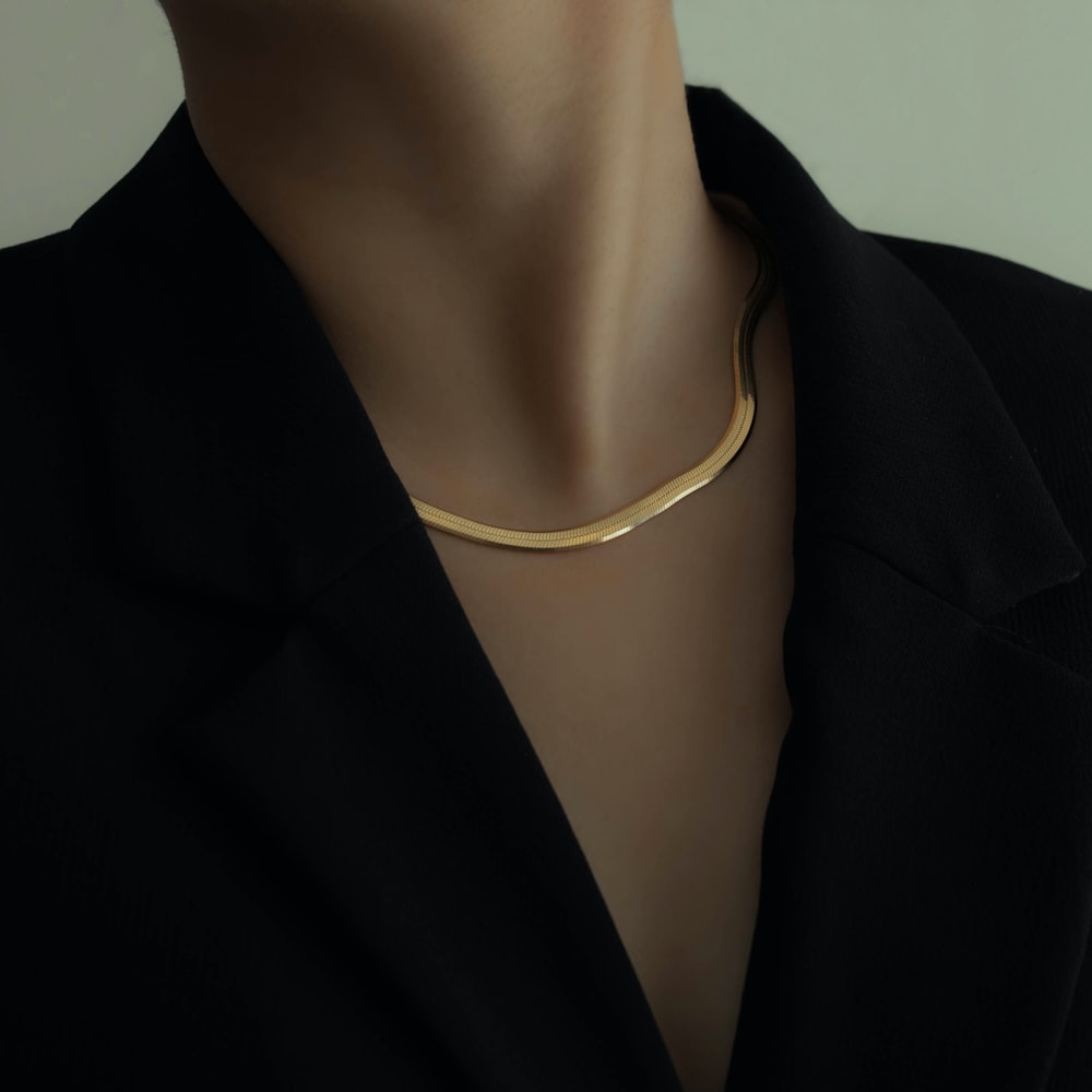 Woman In Black Blazer Wearing Gold Necklace