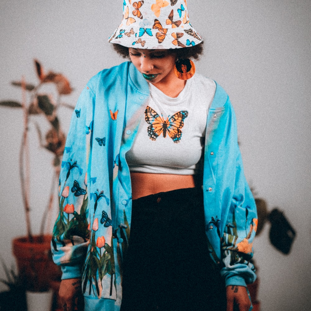 Woman In Blue And White Floral Long Sleeve Shirt And Black Skirt