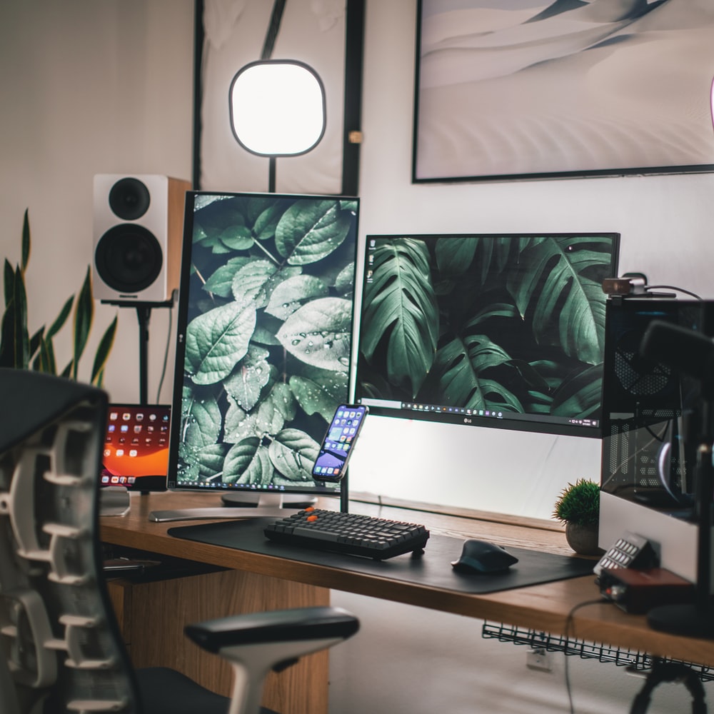 Black Flat Screen Computer Monitor On White Wooden Desk