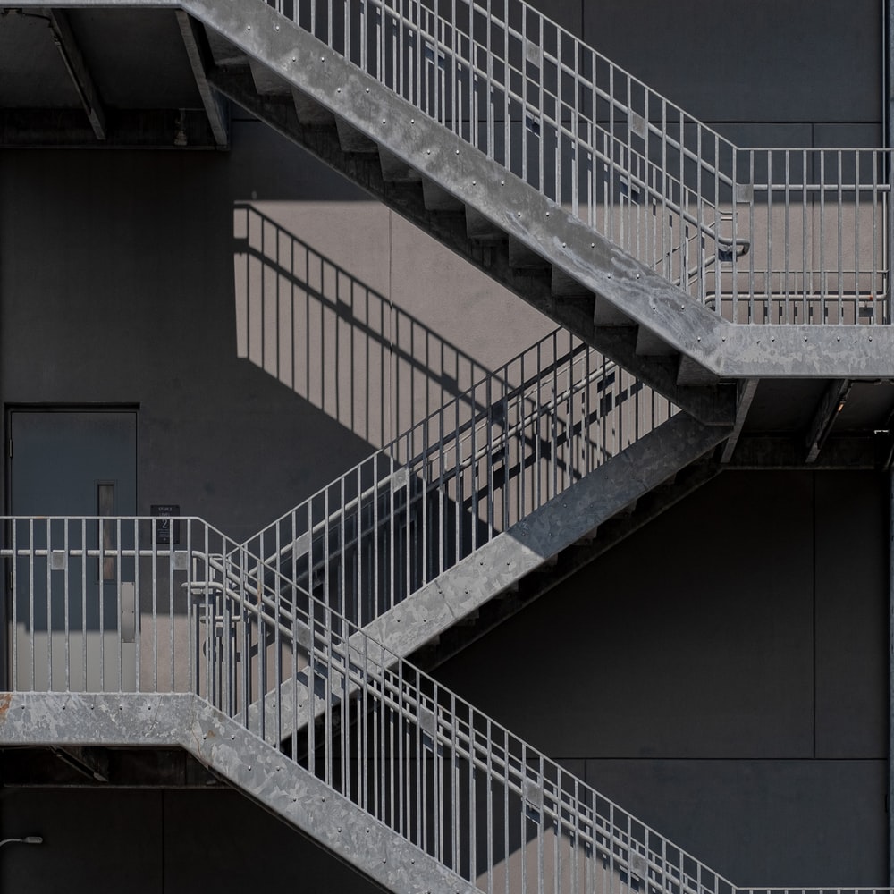 White Metal Staircase On Gray Concrete Floor raster image