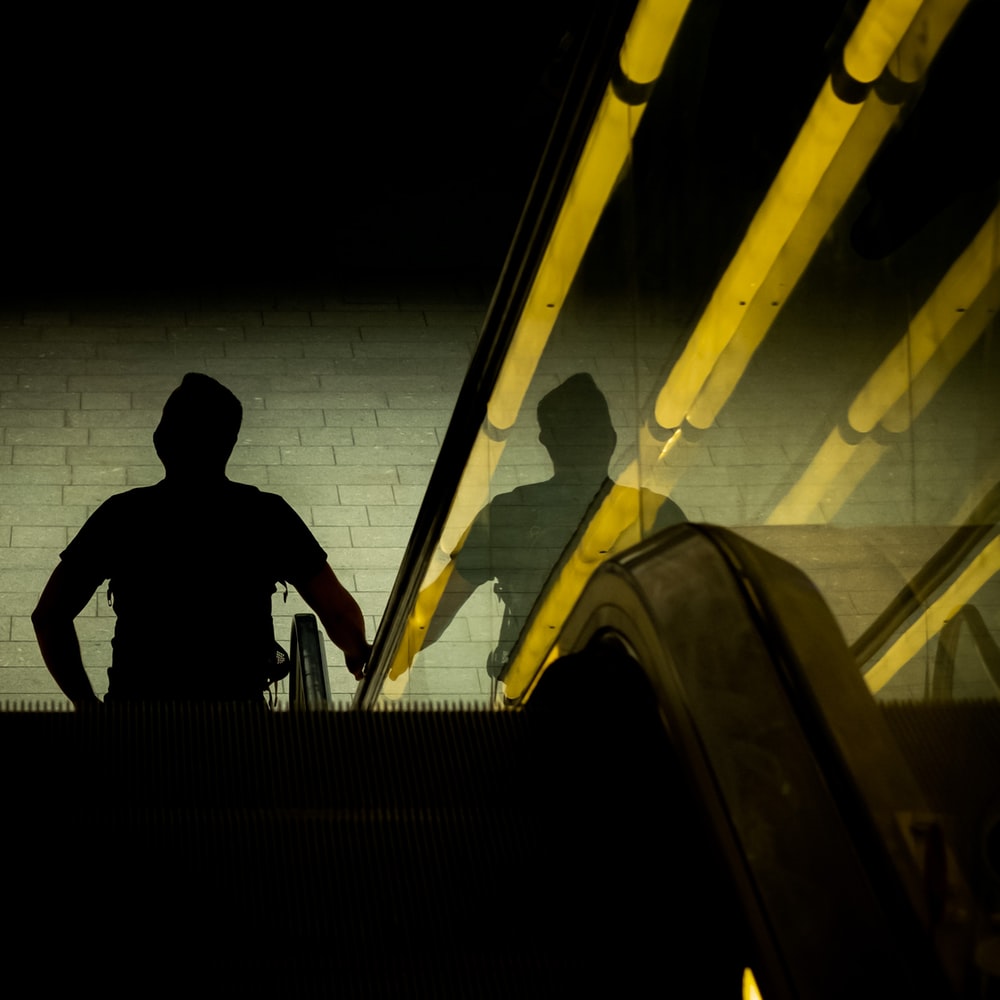 Silhouette Of Man Sitting On Stairs