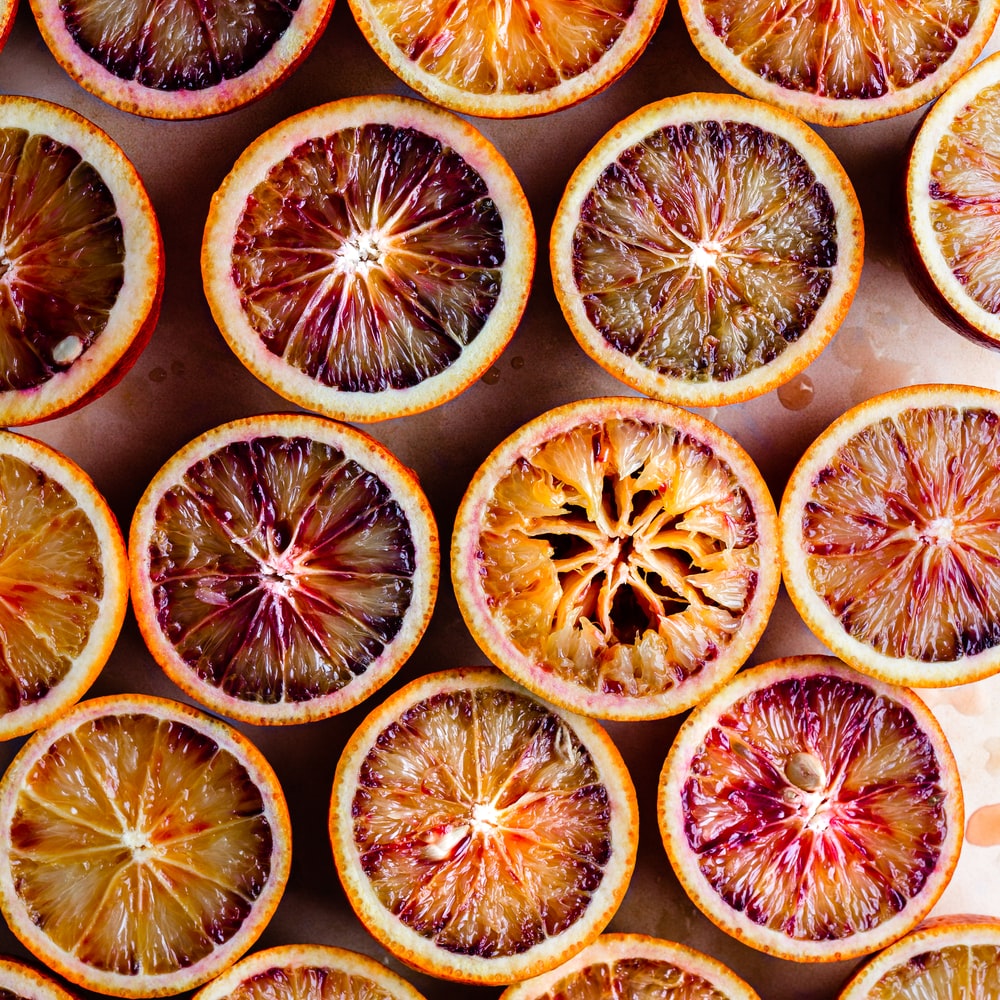 Sliced Orange Fruit On Black Surface raster image