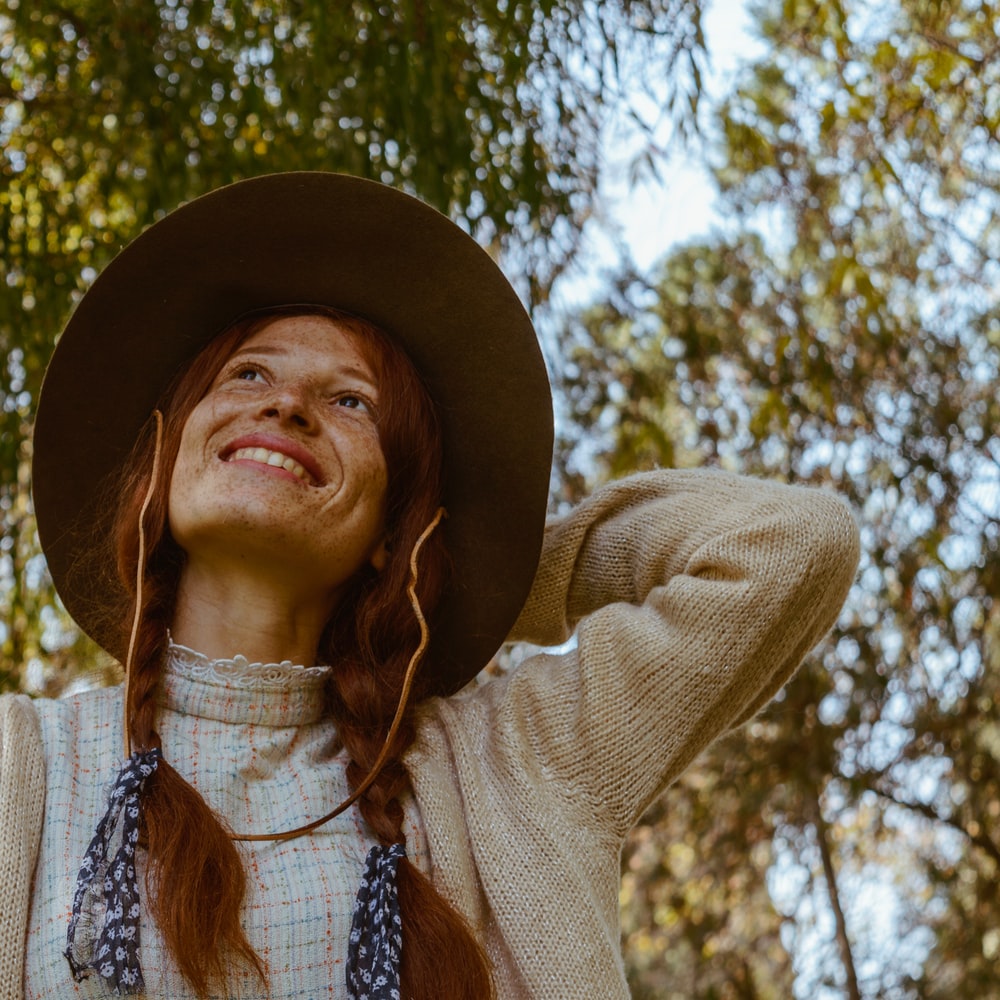 Woman In Beige Cardigan And Brown Hat
