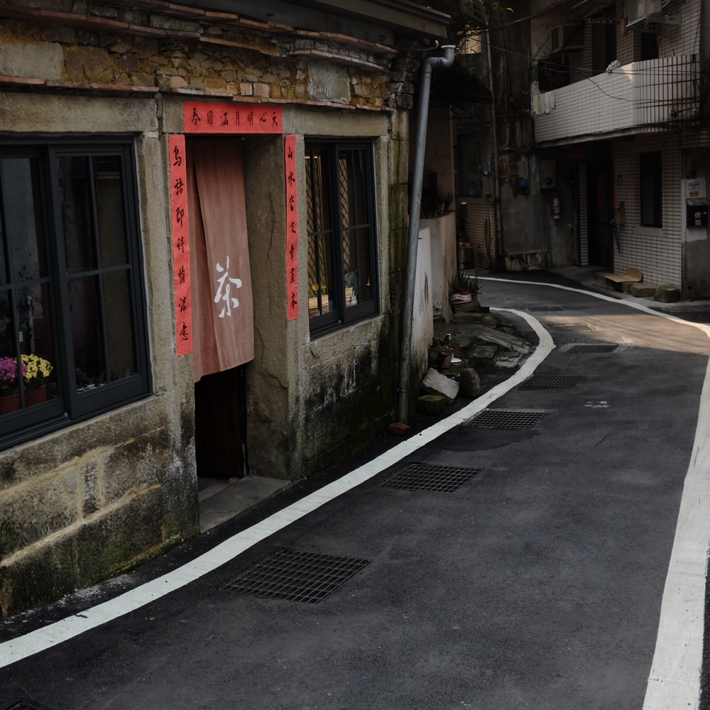 Gray Concrete Building With Red Door raster image