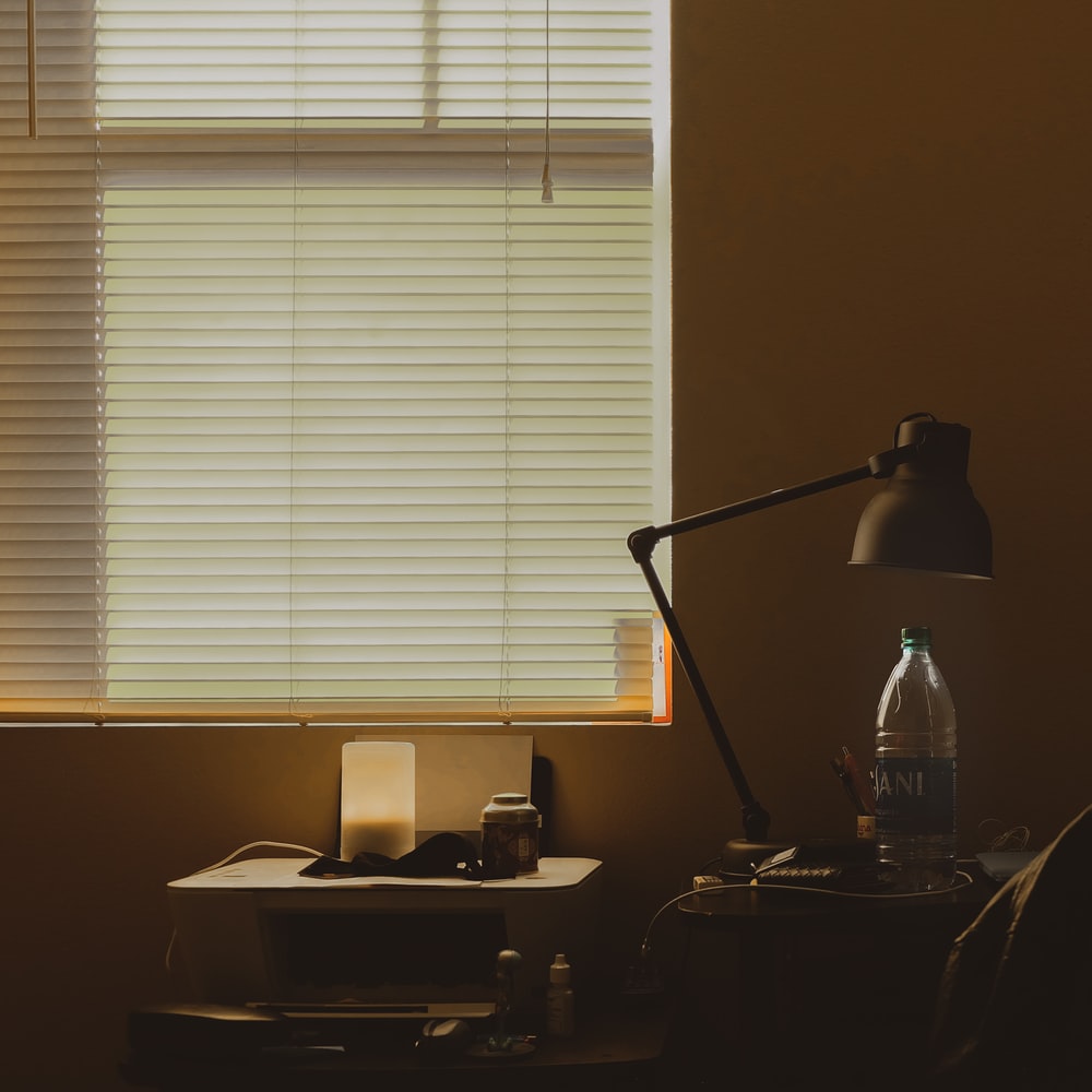 Black Desk Lamp On Brown Wooden Desk raster image