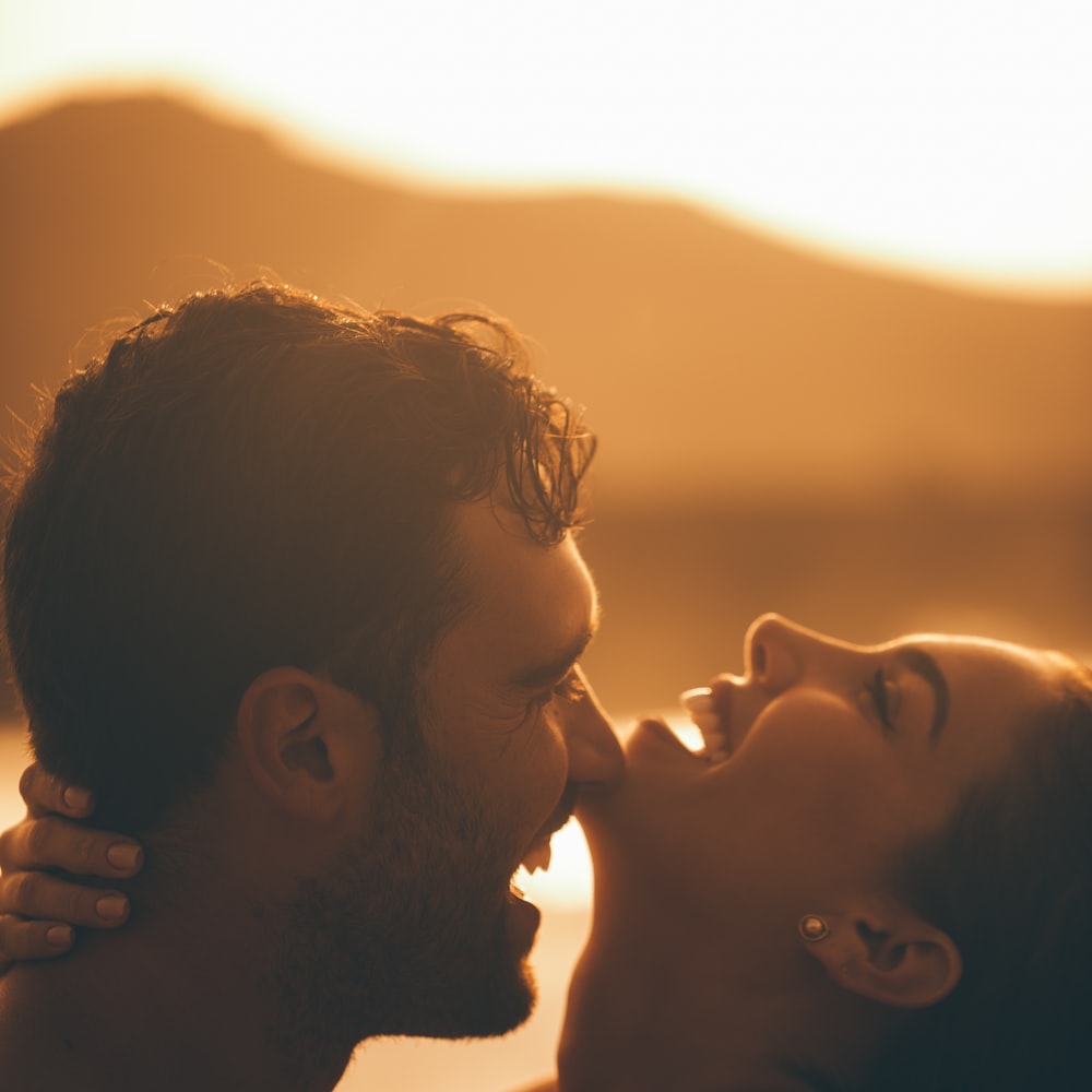 Man And Woman Kissing During Sunset