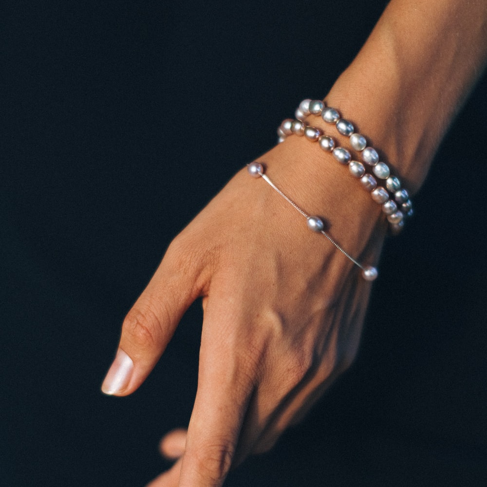 Person Wearing Silver Bracelet And Gold Ring