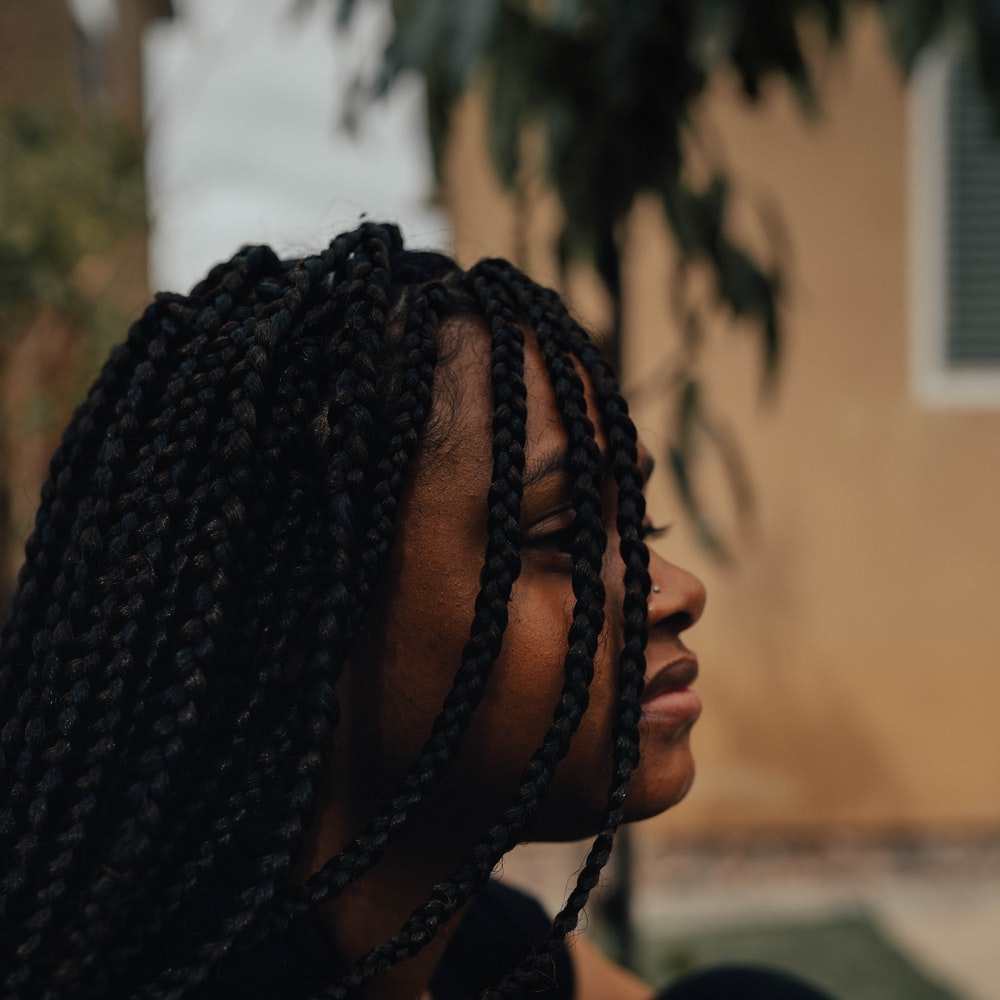 Person With Braided Hair Wearing Black Shirt