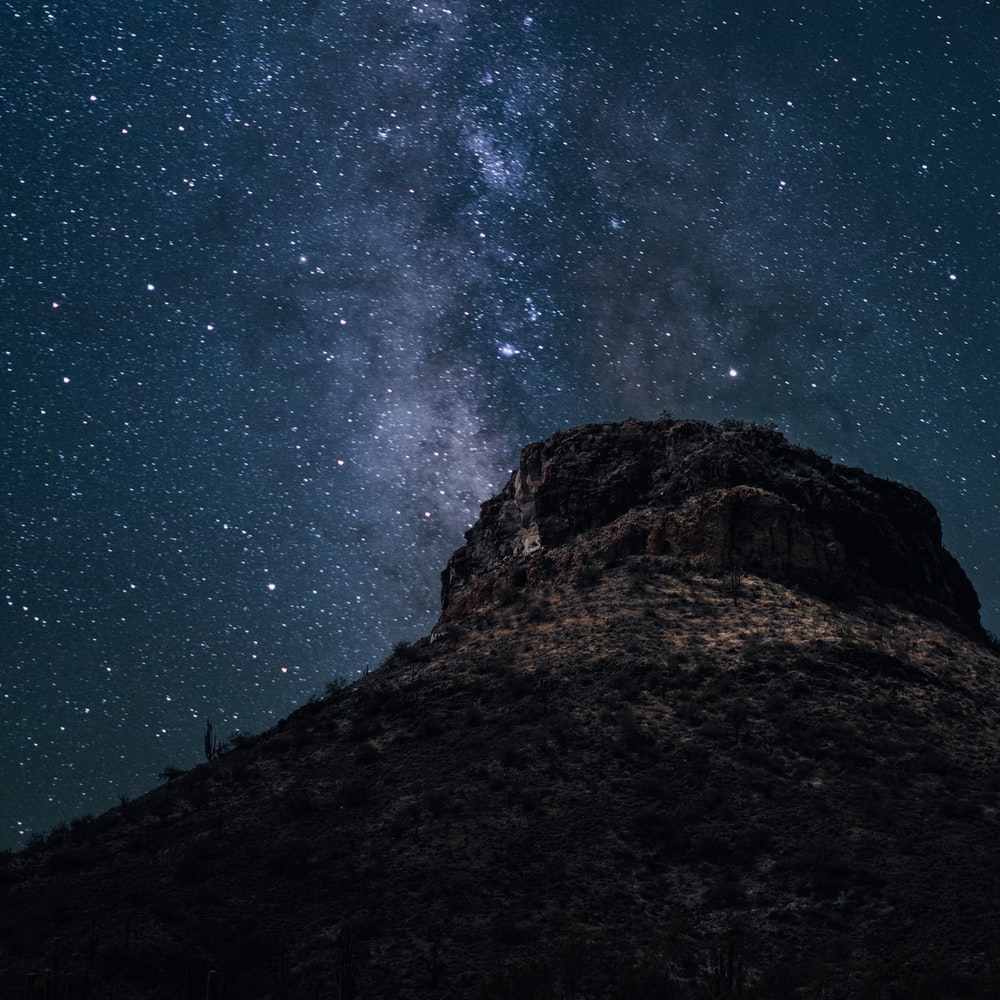 Brown Rocky Mountain Under Starry Night