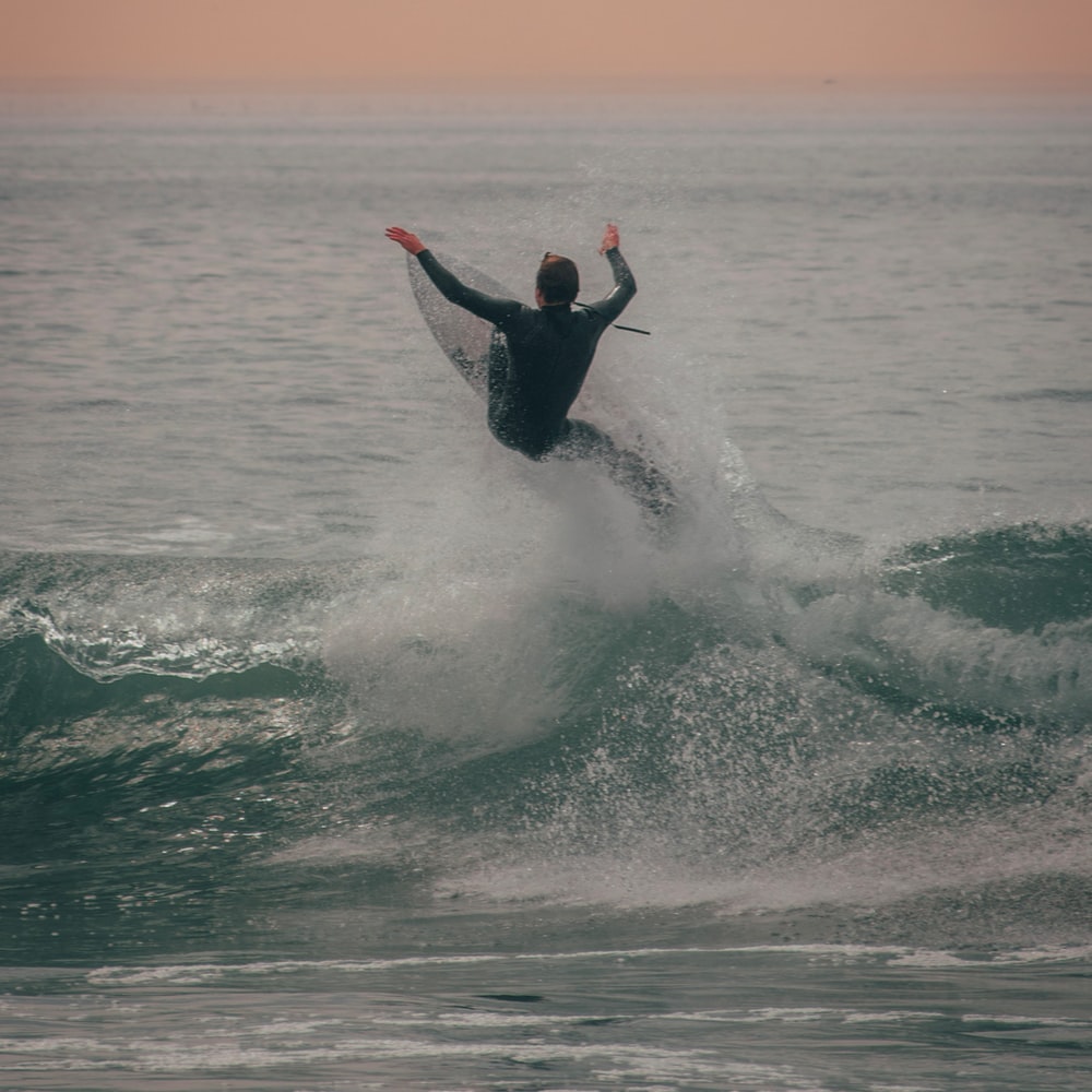 Man Surfing On Sea Waves During Daytime