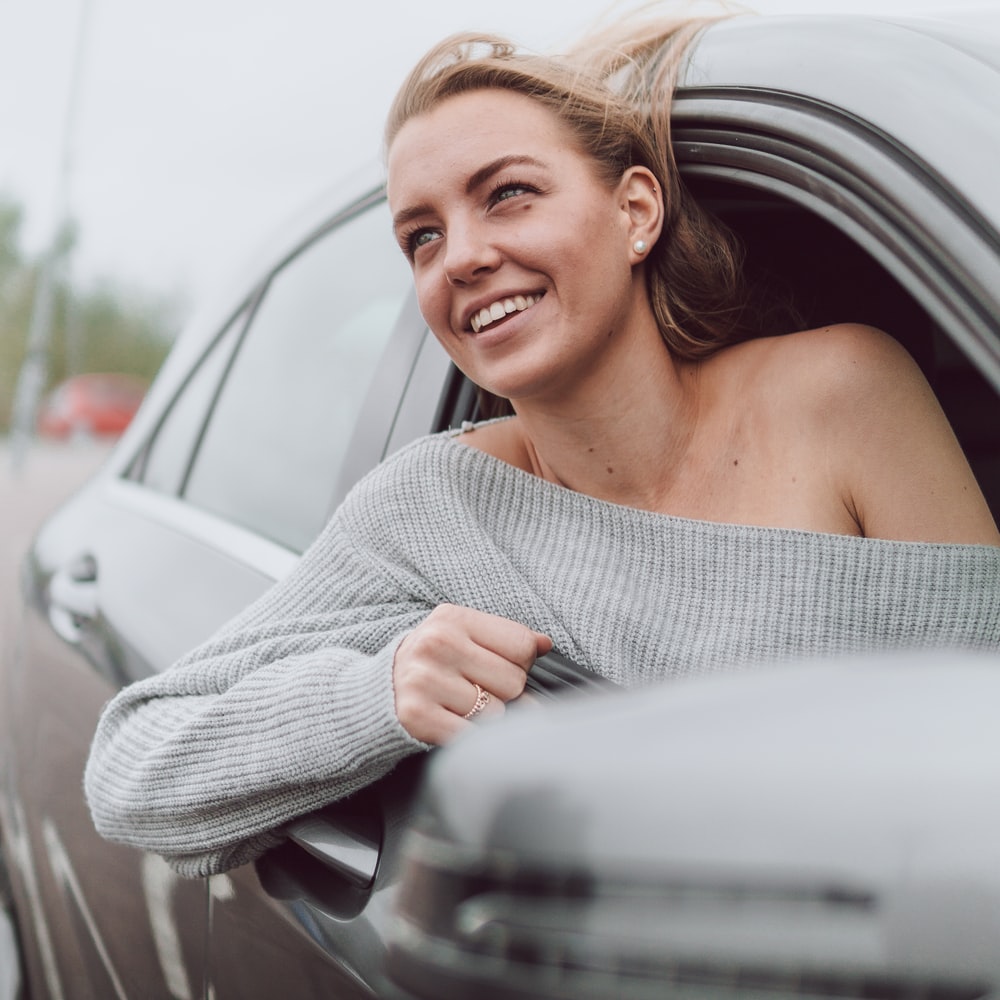 Woman In White Knit Sweater Smiling