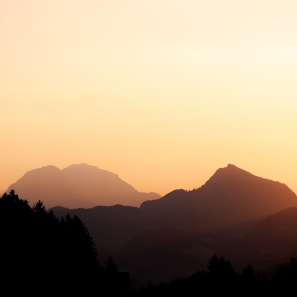Silhouette Of Trees And Mountains During Sunset