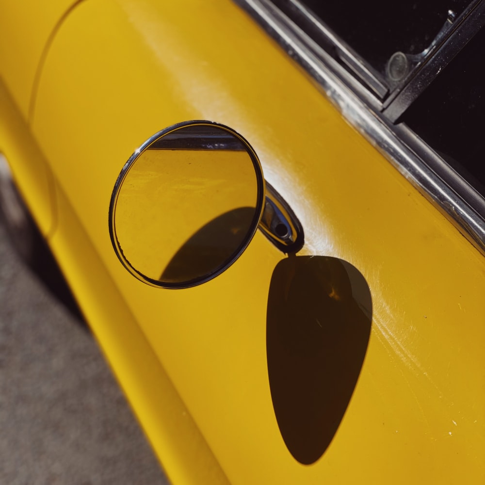 Black Sunglasses On Yellow Car